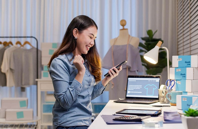 Clothing-Design-Shop-Woman-with-Phone