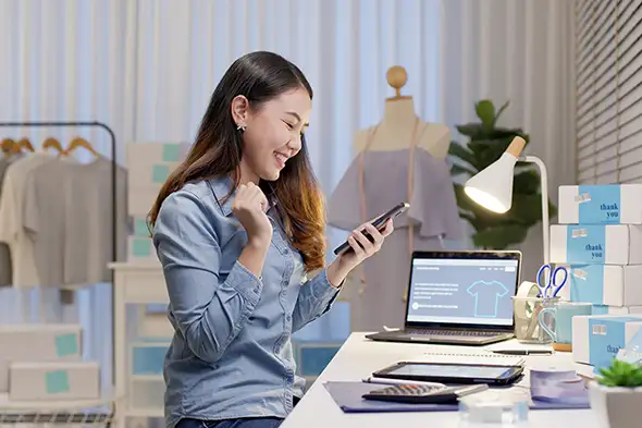 Clothing Design Shop Woman with Phone