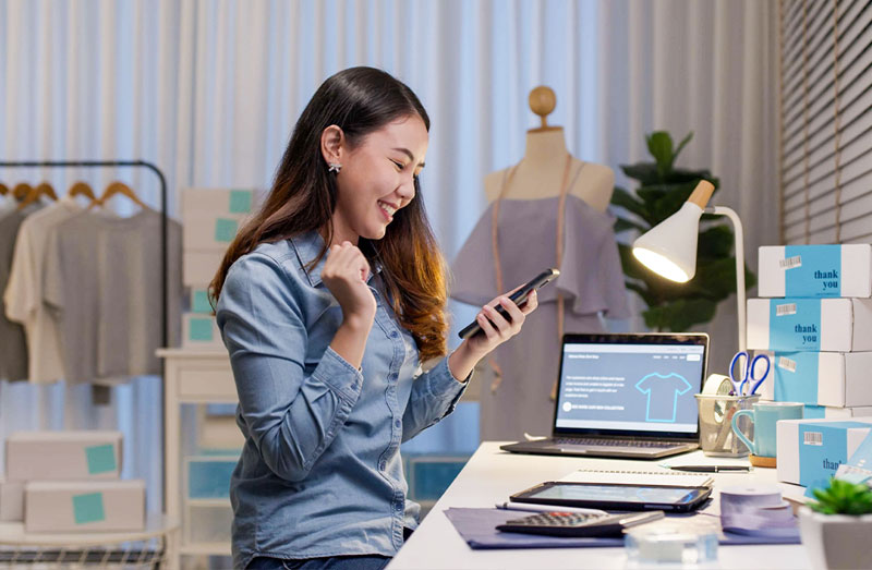 Clothing-Design-Shop-Woman-with-Phone