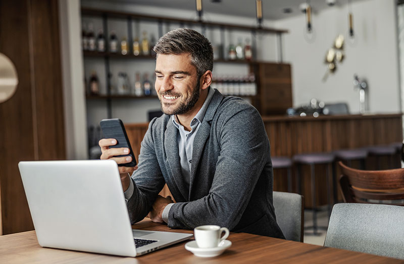 Man at the table with laptop and phone