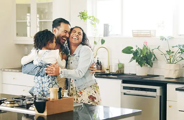 Happy family hugging. First new home.