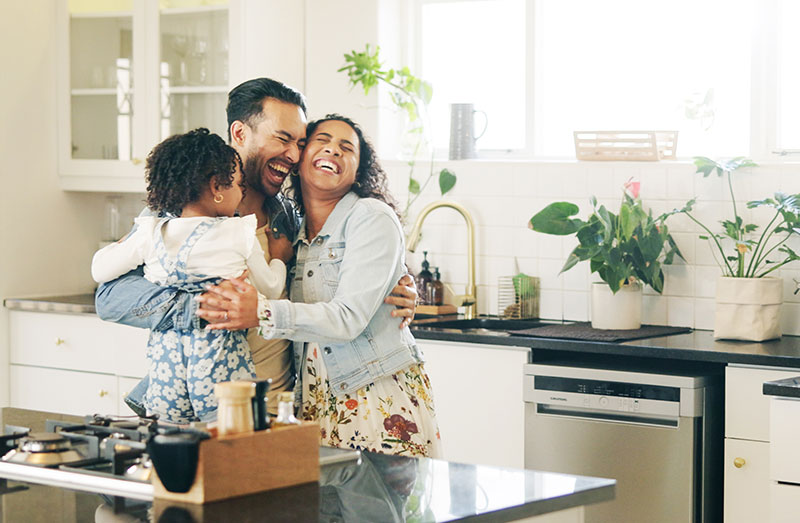happy family hugging first new home